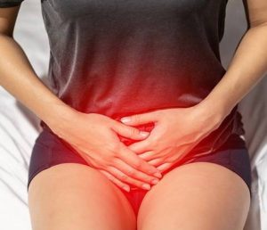 causes-of-pelvic-organ woman holding pelvic region