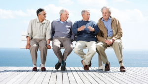 four older men sitting on bench
