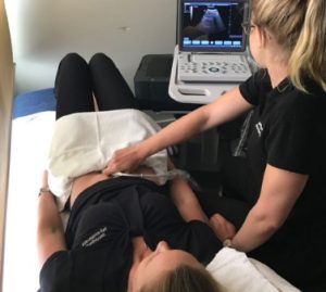 Symptom-management-ultrasound Doing an ultrasound on a female patient